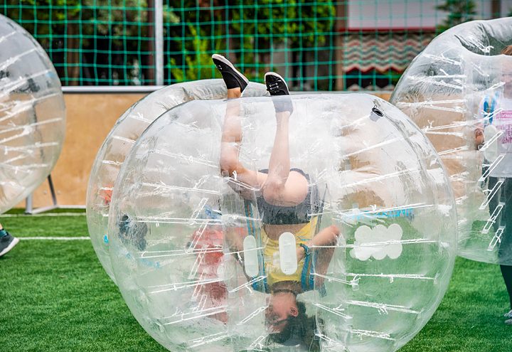 Player rolling upside down inside his bubble on the pitch